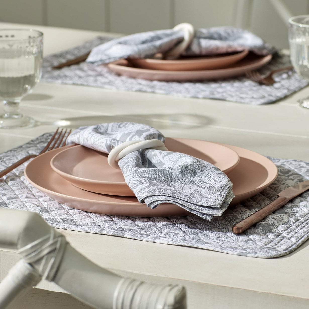table place setting with cotton napkins in gray paisley pattern