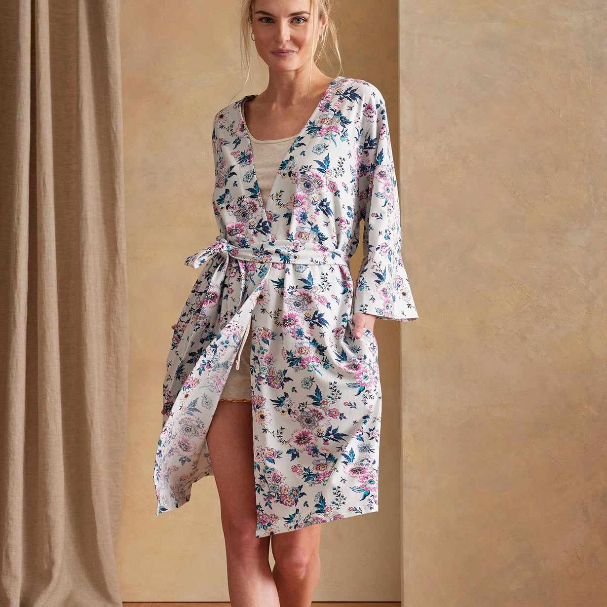 model wearing soft knit robe with floral pattern