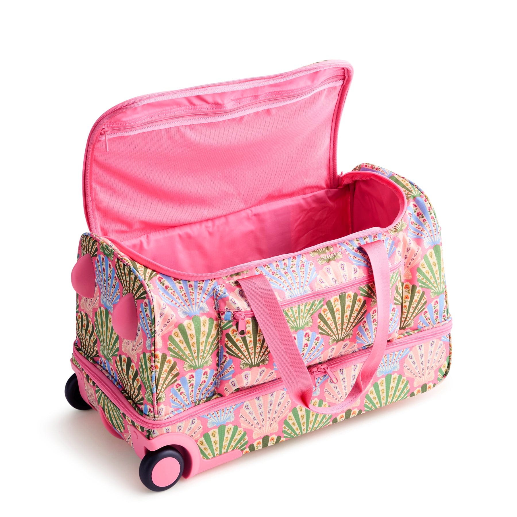 pink duffel bag with yellow blue and green shells pattern and wheels shown with top compartment unzipped and pink interior