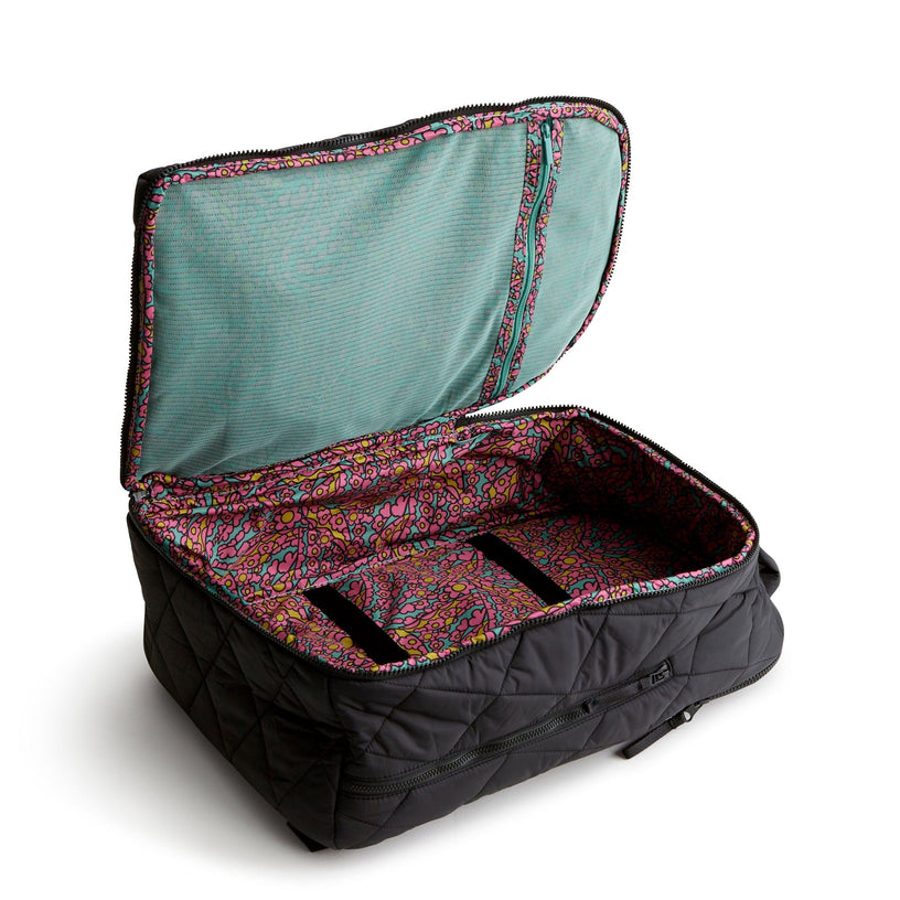 lightweight black quilted travel backpack shown open with colorful interior pattern