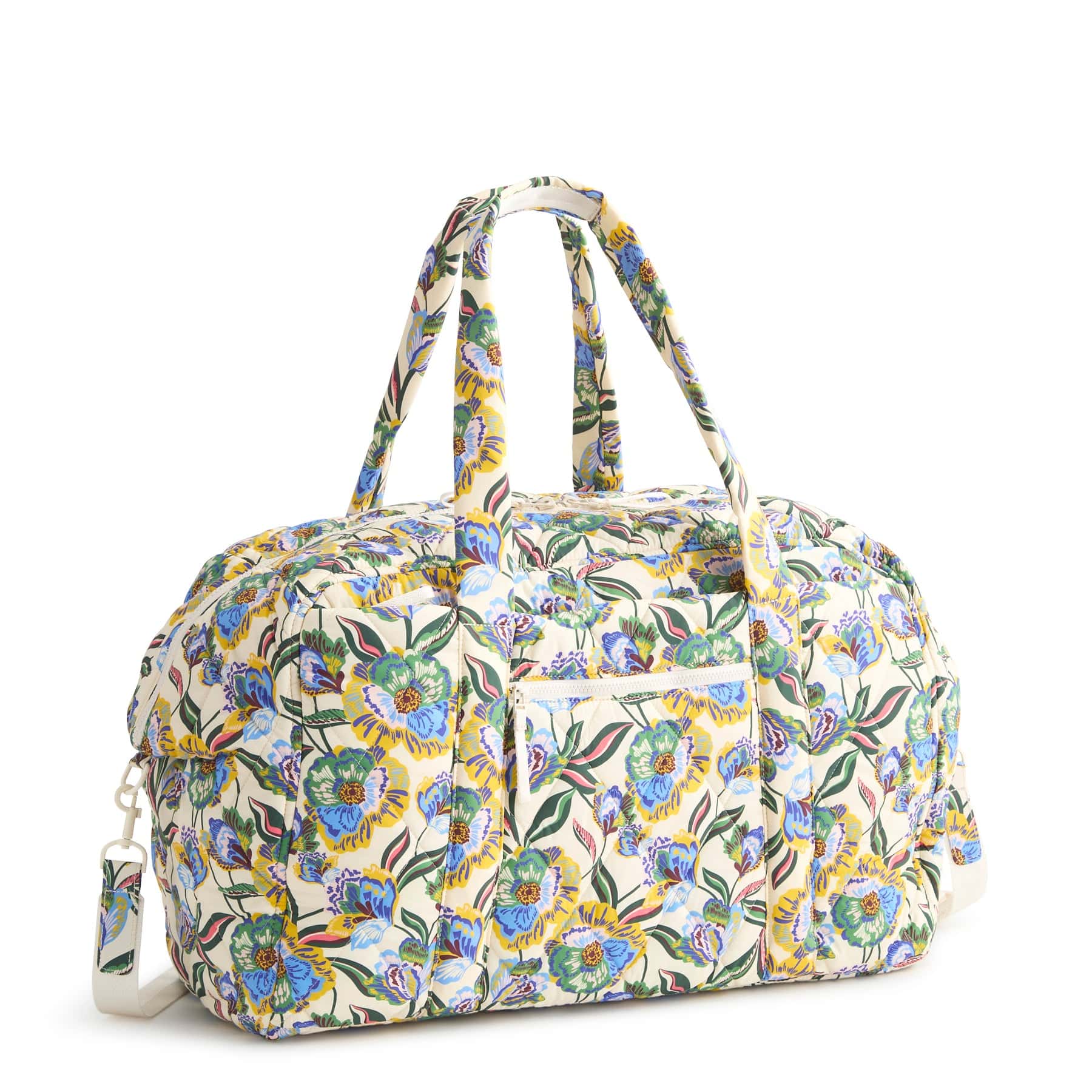 cream colored lightweight quilted duffel bag with blue yellow and green floral pattern