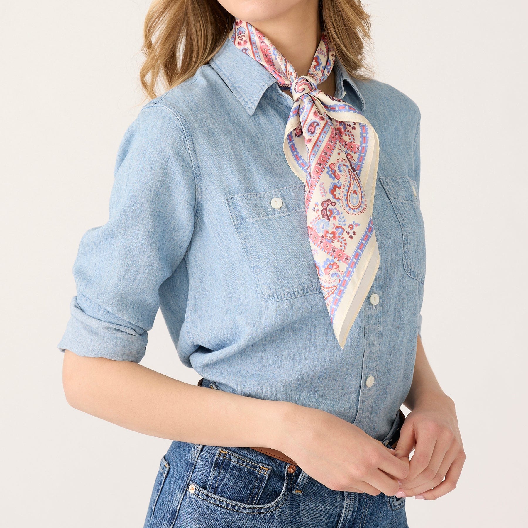 model wearing denim clothes with cream and paisley silk scarf tied around neck