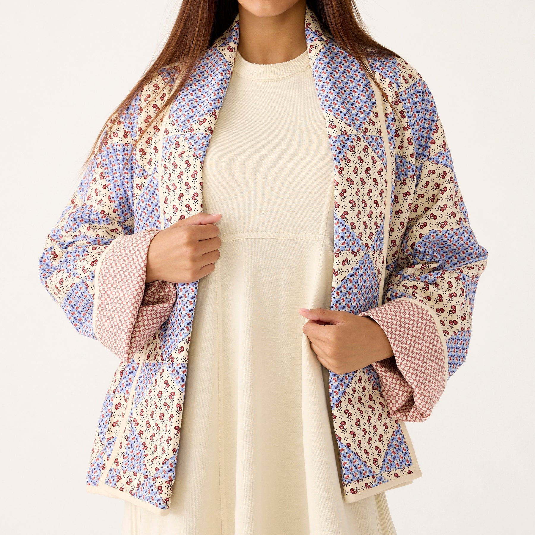 model wearing cream dress and quilted patchwork cotton jacket