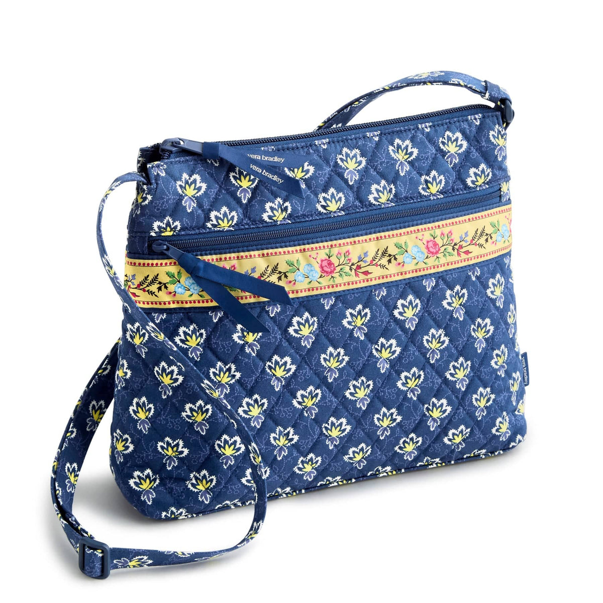 dark blue quilted purse with small yellow flowers pattern and bright yellow floral pattern band
