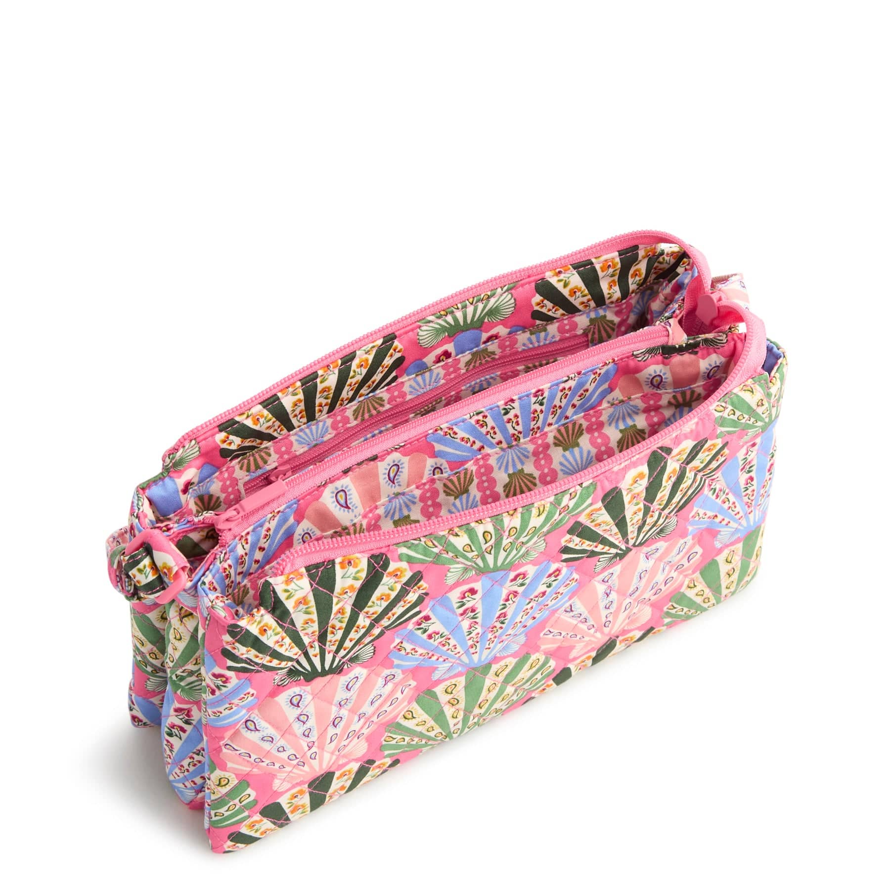 pink quilted crossbody bag with shells pattern shown zippered open with two spacious interior compartments