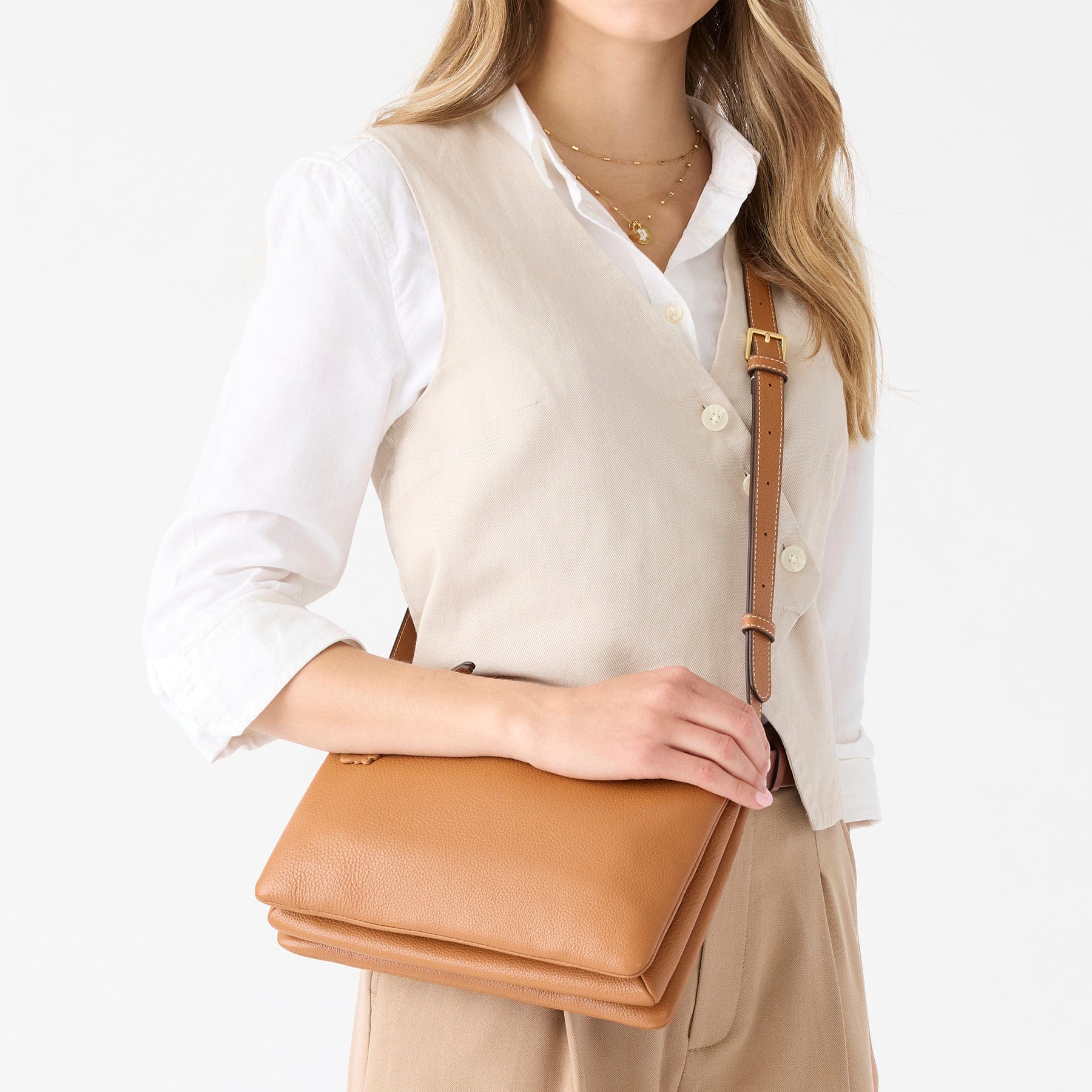 pink quilted crossbody bag with shells pattern shown zippered open with two spacious interior compartments