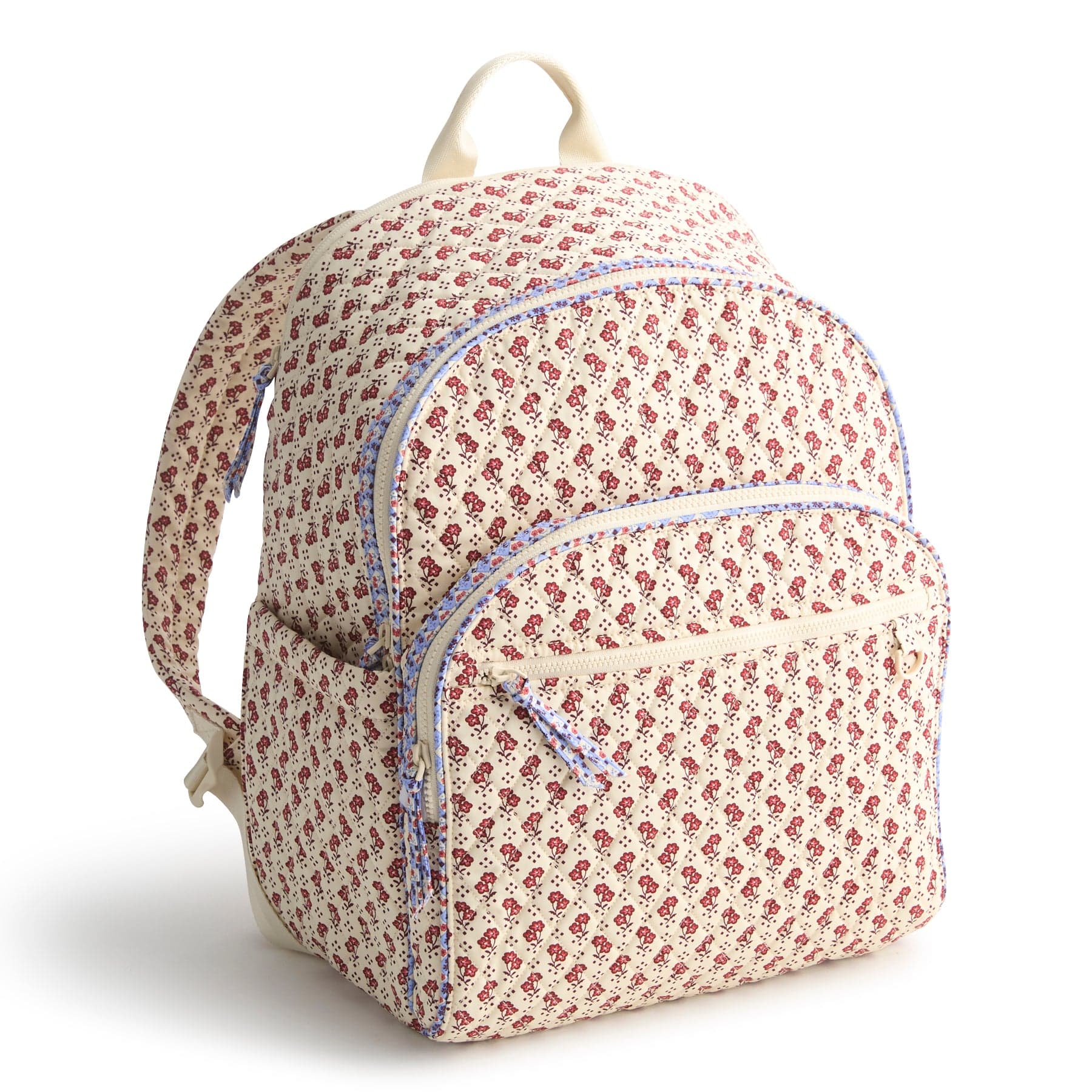 cream colored backpack with small red flowers pattern and blue trim