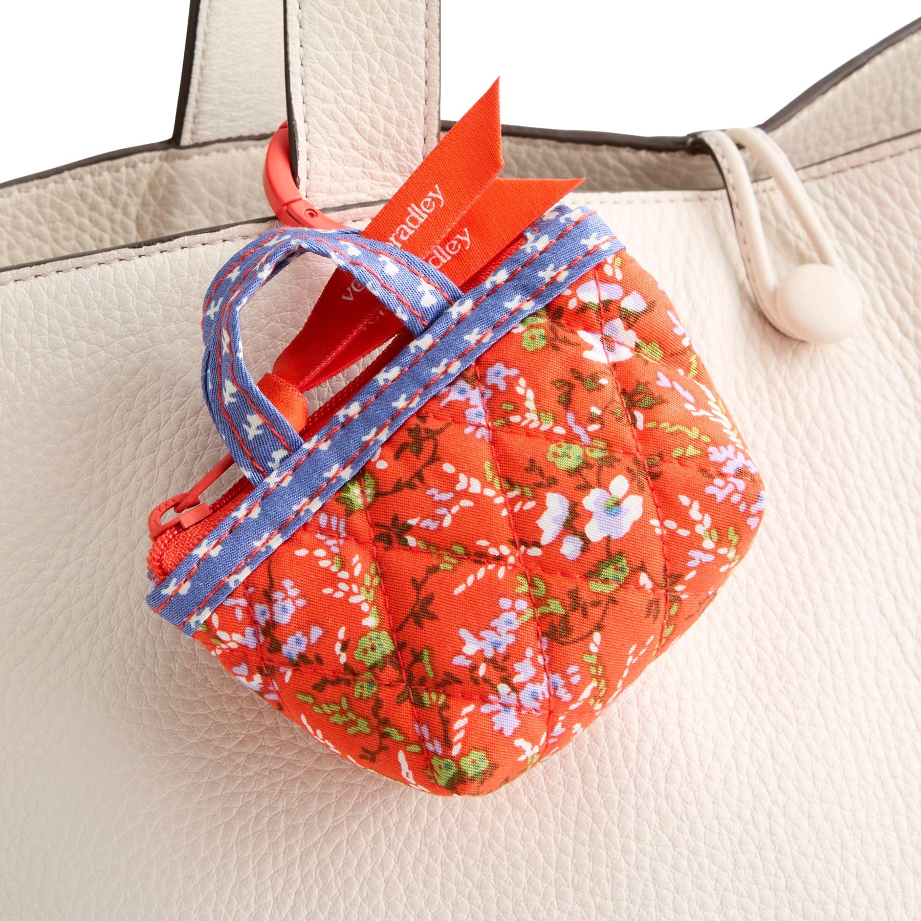 miniature red floral vera bradley tote bag charm shown with metal hinge ring around handle on cream leather purse