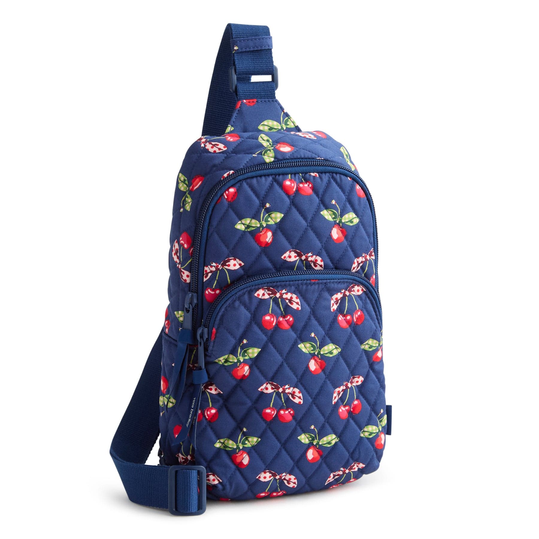 navy blue quilted cotton sling backpack with two zippered compartments and red cherries and bows pattern