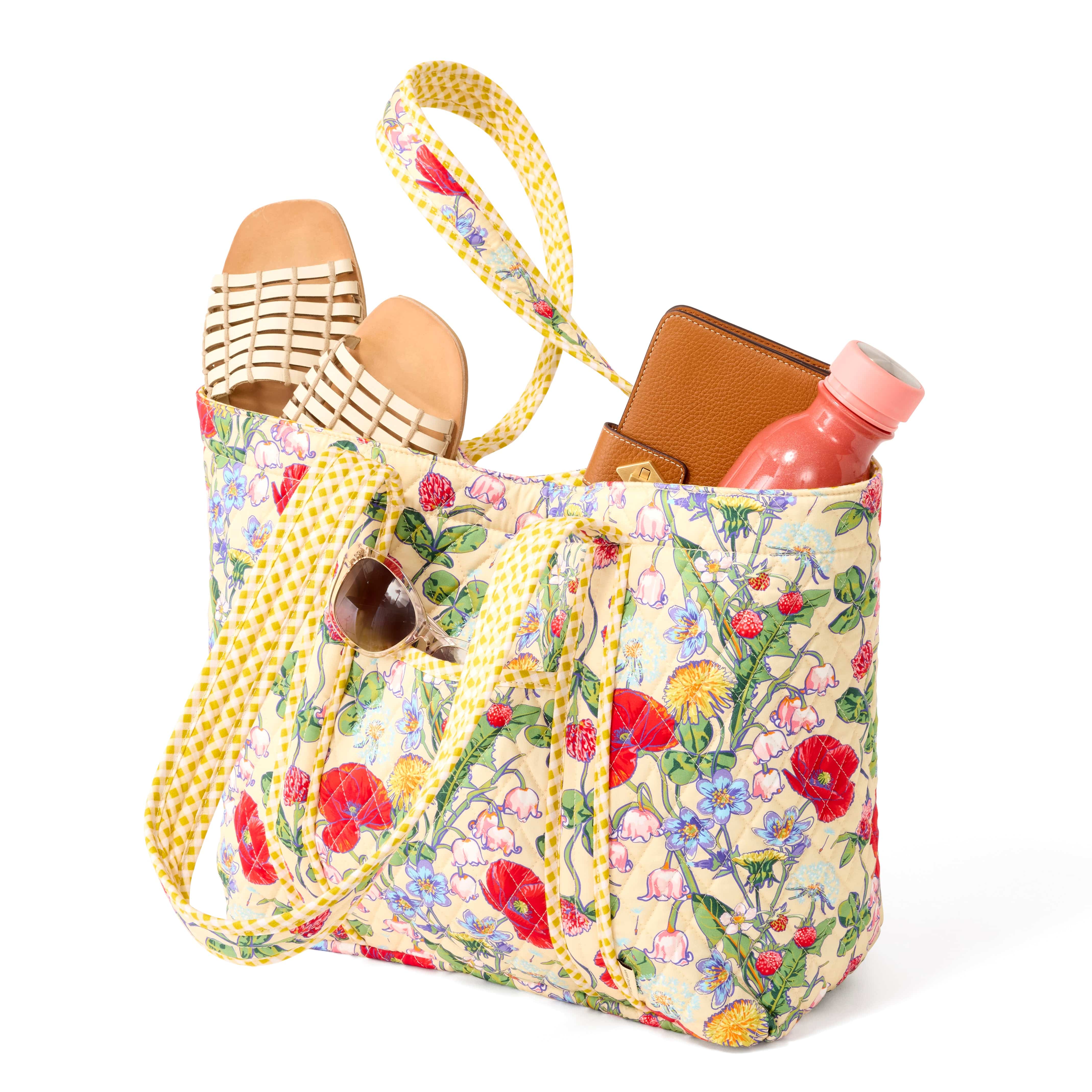 large yellow quilted cotton tote bag with wildflowers pattern and flip flops water bottle and wallet extending from top