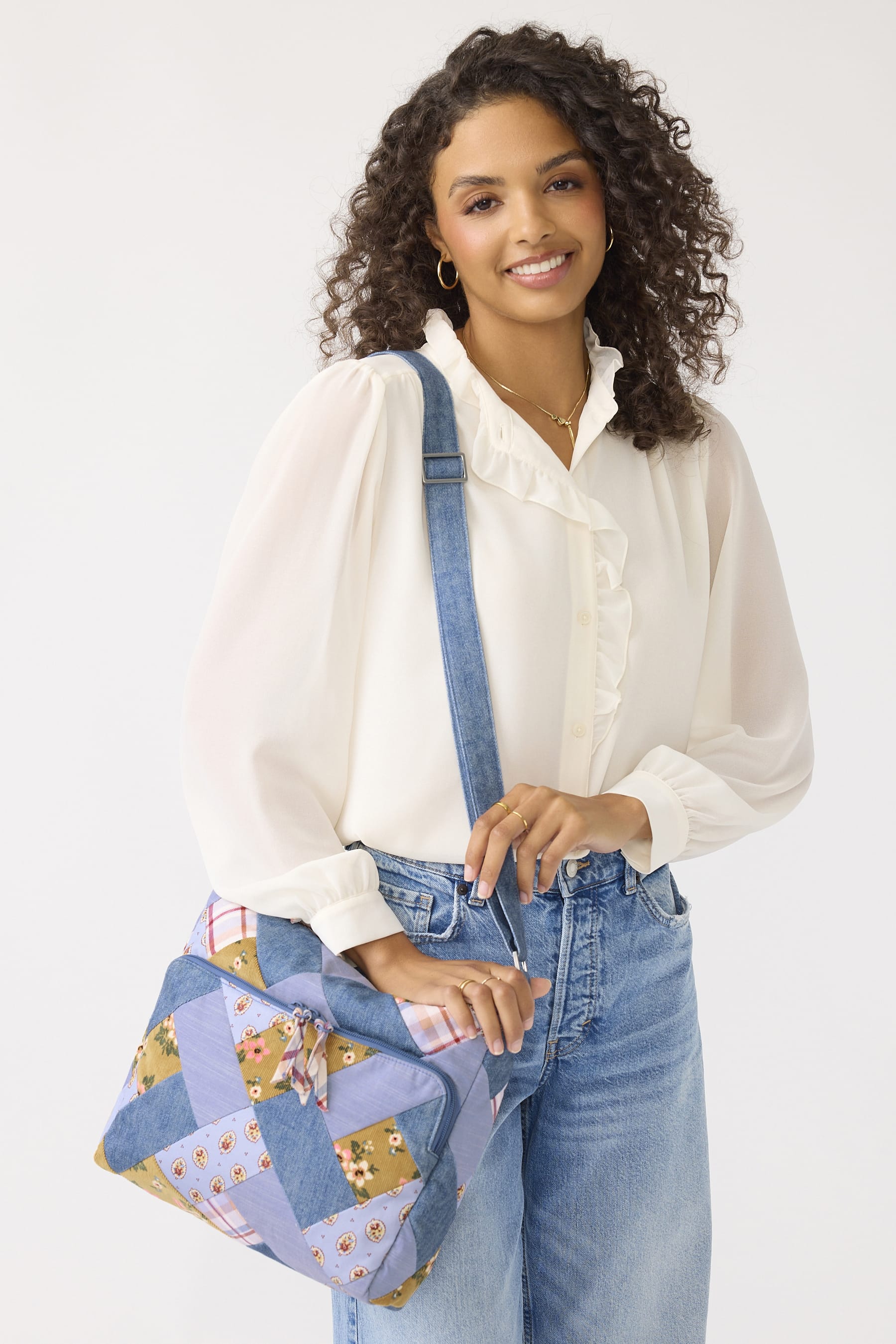 model wearing gold dress and brown jacket with cream quilted cotton crossbody bag with paisley and birds pattern